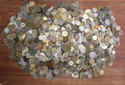a pile of coins sitting on a wooden table