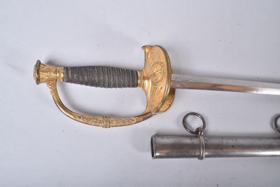 a sword and two other items on a white surface