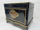 a black and gold chest with a clock on it