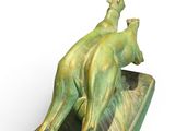 a statue of two animals on a boat on a white background