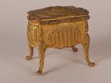 a gold colored box with a design on it