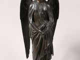 an image of a statue of an angel on a wooden base