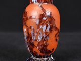 a vase that has a brown and white design on it