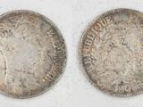 two silver coins, one of which is a woman and one of which is a man