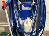 a blue hose attached to a blue machine in a kitchen