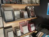 many framed pictures on the wall of this room