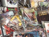 a pile of comic books sitting on a table