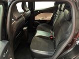 the back seats of a car with the door open and the driver ' s seat folded down
