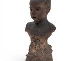 an old wooden bust of a child on a white background