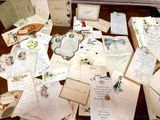 a table with a bunch of old letters and papers on it