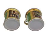 pair of gold and white coffee cups with a picture of a man and woman on them