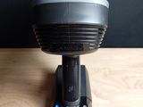 a small fan sitting on top of a table next to a cell phone