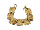 a close up of a gold bracelet on a white background