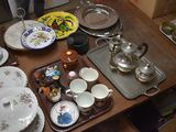 many plates and bowls on a table with a tea pot