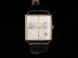 a close up of a watch on a black background