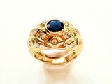 une photo en gros plan d'une bague sertie d'une pierre bleue