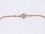 a close up of a gold chain bracelet on a white background