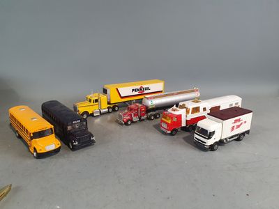 several toy trucks are lined up in a row on a gray surface