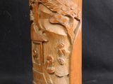 an old wooden vase with carvings on it on a black background