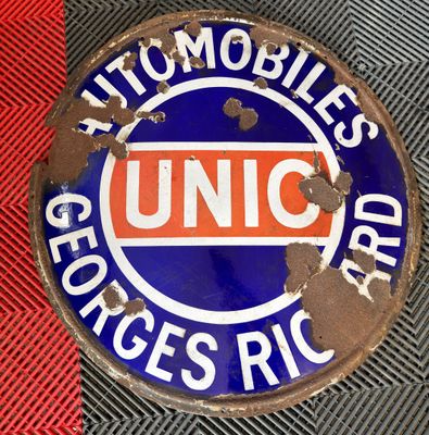 un panneau bleu et orange posé sur un sol rouge et noir