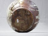 a brown and white vase sitting on a white surface
