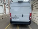 a white van that is parked on the side of the street