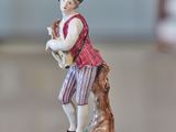 a figurine of a man with a dog on a table