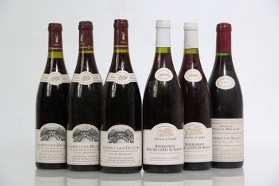 six bottles of wine are lined up in a row on a table