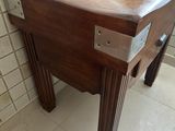 a wooden table with a drawer on it in a bathroom