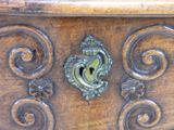 a close up of a wooden box with a keyhole on it
