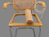an image of a wicker chair with a rope on top of it