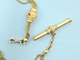 an image of a gold necklace with a bar and a chain