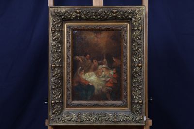 un vieux tableau représentant un homme tenant un bébé, posé sur un chevalet