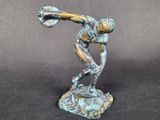 statue of a man holding a baseball bat on a black surface