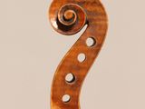an old violin with a wooden back and a long neck