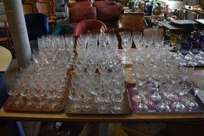a lot of wine glasses on a table in a room