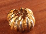 a gold ring that has been placed on a wooden table