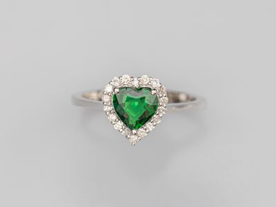 a heart shaped emerald and diamond ring