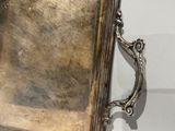 a mirror with a silver frame on the wall