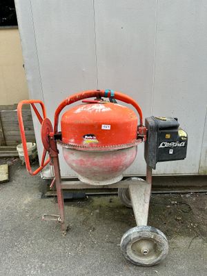 an orange machine that is sitting on the ground