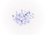 a pile of clear glass beads on a white surface