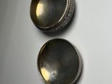 pair of antique silver plated bowls on a white surface