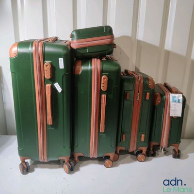 several pieces of luggage sitting on top of each other on a table