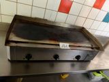 a metal counter top with a pizza oven on it