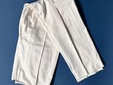 a close up of a pair of white pants on a blue surface