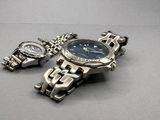 two watches that are sitting next to each other on a table