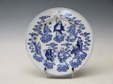 a blue and white plate with a design on it