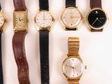 several different types of watches are lined up on a white surface