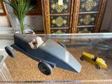 a toy car and a toy truck sitting on a glass table