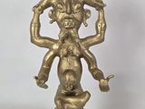 an image of a gold statue of a man holding a snake